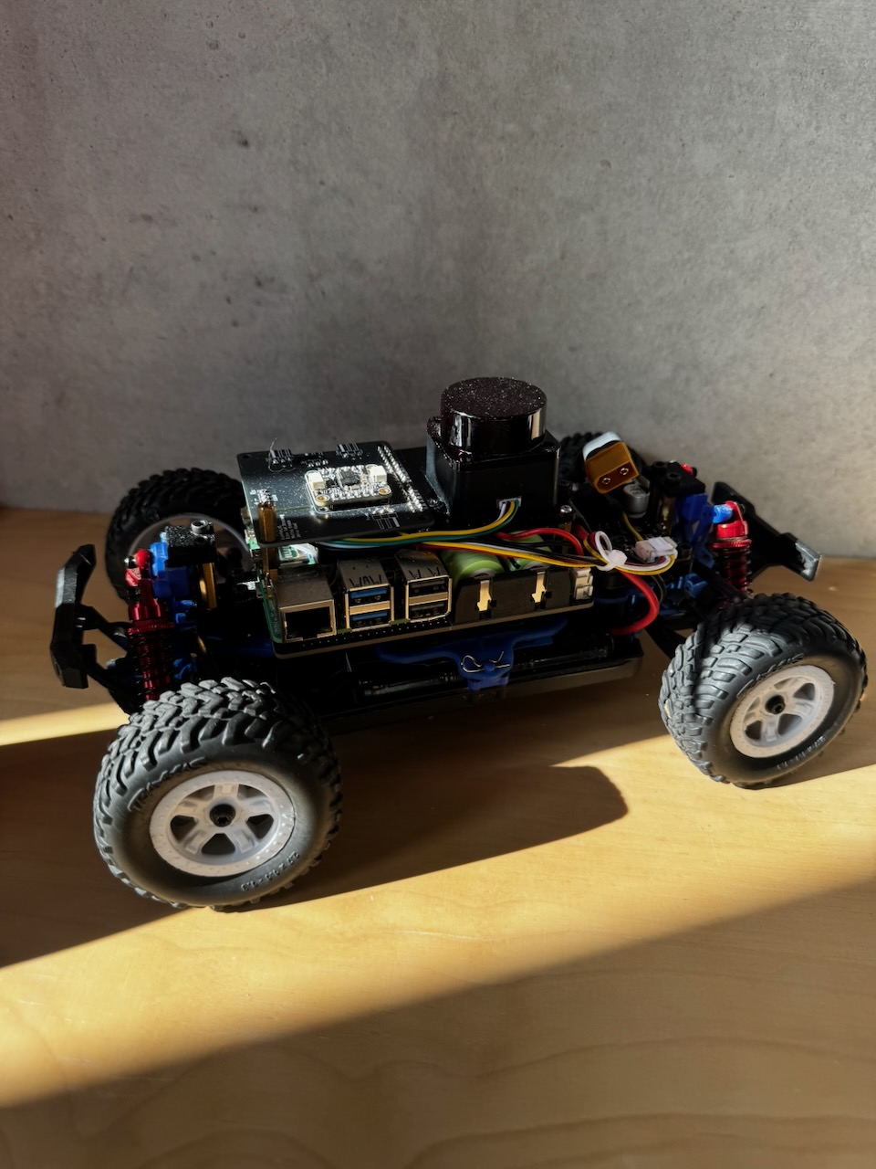 The physical PreRunner vehicle: a 1/18-scale RC platform converted into a self-contained ROS 2 research vehicle