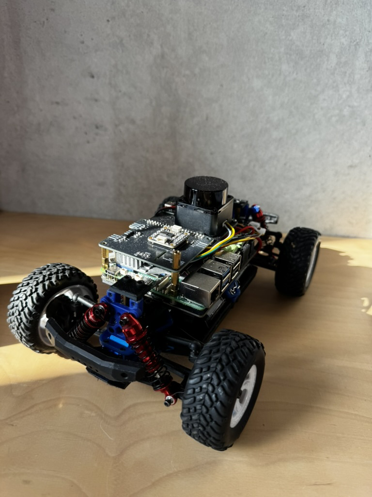 Close-up of the PreRunner onboard compute stack: Raspberry Pi 5, IMU, and wiring mounted to the chassis