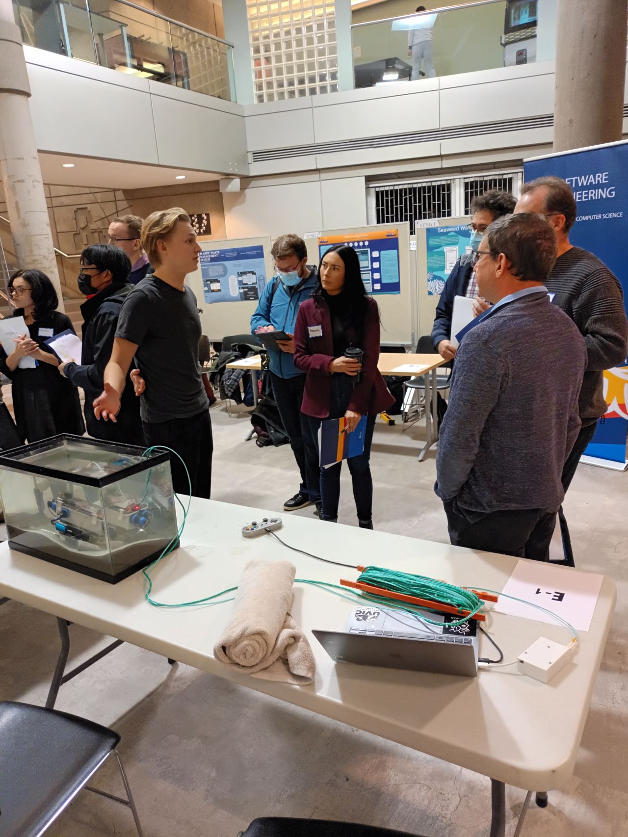 Mattias Kroeze demonstrating the sediment-sampling ROV in a test tank to competition judges
