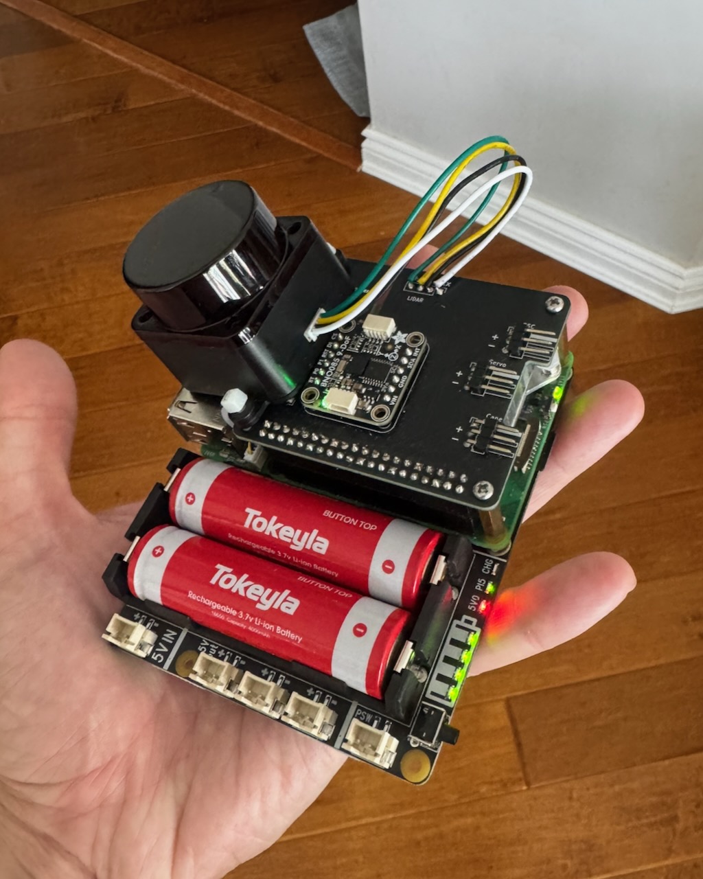 Early PreRunner onboard sensing and compute electronics stack held in one hand